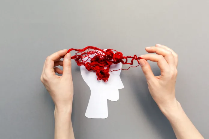 tangled-red-threads-on-the-silhouette-of-the-head-representing-the-brain-blue-background-flat-lay-the-concept-of-mental-health-and-demension-stockpack-istock Tangled red threads on the silhouette of the head, representing the brain. Blue background. Flat lay. The concept of mental health and demension