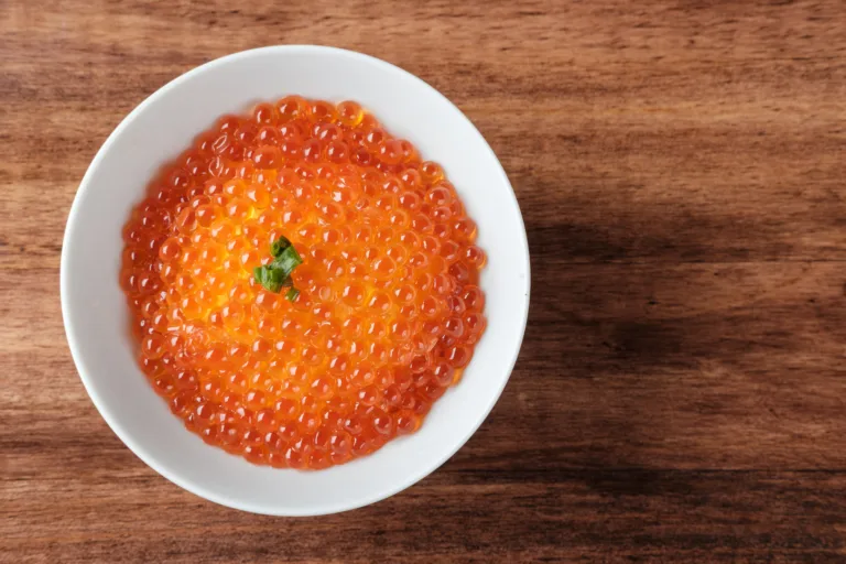 Top View of Salmon Roe (Ikura) in a White Bowl with copy space for your text.