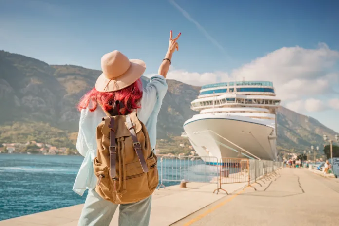 tourist-wearing-backpack-and-hat-gesturing-near-cruise-ship-at-kotor-bay-montenegro-stockpack-istock Tourist wearing backpack and hat gesturing near cruise ship at Kotor bay, Montenegro
