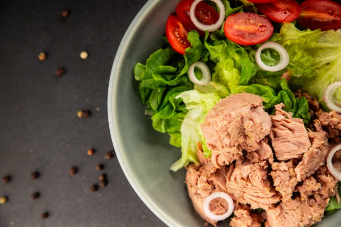 Tuna salad green leaf lettuce, canned tuna, tomato fresh delicious gourmet food background on the table rustic food top view copy space keto and paleo diet vegetarian food pescetarian diet