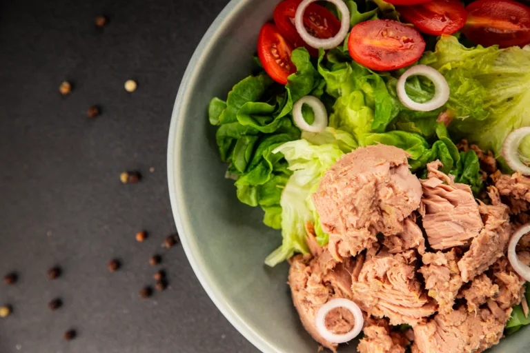 Tuna salad green leaf lettuce, canned tuna, tomato fresh delicious gourmet food background on the table rustic food top view copy space keto and paleo diet vegetarian food pescetarian diet