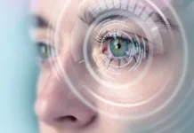 Novo odkritje bi lahko spremenilo zdravljenje bolezni oči A close-up captures a person's eye surrounded by a digital interface, suggesting themes of technology, vision enhancement, and biometric recognition. The eye exhibits vibrant colors.