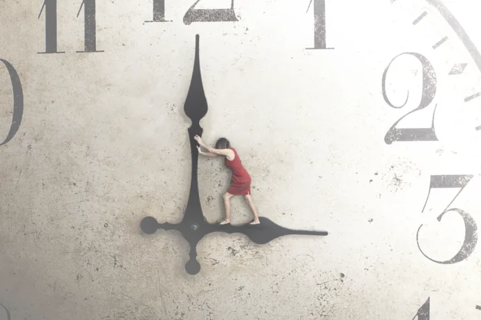 business-woman-tries-to-stop-the-time-stockpack-istock business woman tries to stop the time