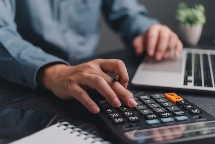 businessman-using-calculator-bookkeeping-payroll-and-budget-tax-business-document-finance-accounting-investment-stockpack-istock Businessman using calculator bookkeeping payroll and budget tax. Business document finance accounting investment