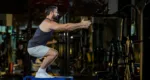 Caucasian man with strong and muscular firm shape is training on leg day by doing advance jump squat for thigh and calf muscle in gym for healthy and strong lower body weight strength
