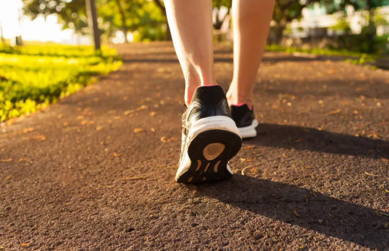 Close up woman walking on a path. Fitness concept.