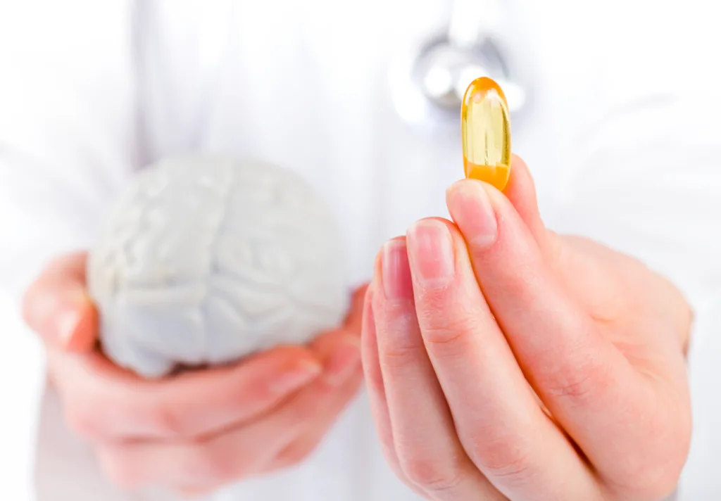 Closeup photo of doctor holding omega 3 capsule in hand