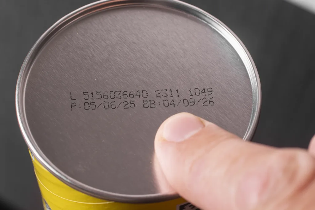 Date of manufacture and expiration date on a metal can.