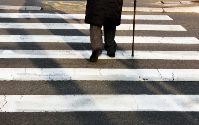 legs-and-shadow-of-a-senior-person-using-walking-cane-while-crossing-the-street-in-motion-blur-stockpack-istock Legs and shadow of a senior person using walking cane while crossing the street in motion blur
