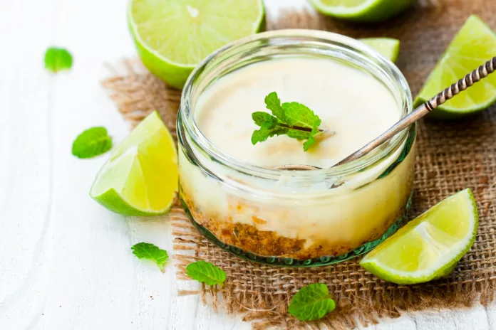 mini-lime-cheesecake-in-a-glass-pot-on-white-wooden-background-stockpack-istock Mini lime cheesecake in a glass pot on white wooden background