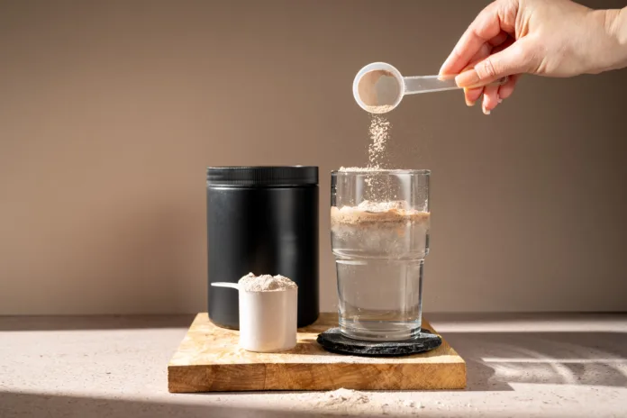 protein-shake-and-chocolate-protein-powder-in-a-scoop-sports-nutrition-stockpack-istock Protein shake and chocolate protein powder in a scoop, Sports nutrition.