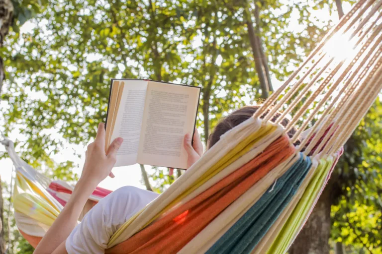 reading at dusk in the hammock with the open book