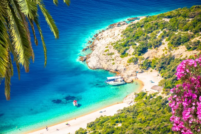Secret turquoise beach below Lubenice village on Cres island, scenic archipelago of Croatia