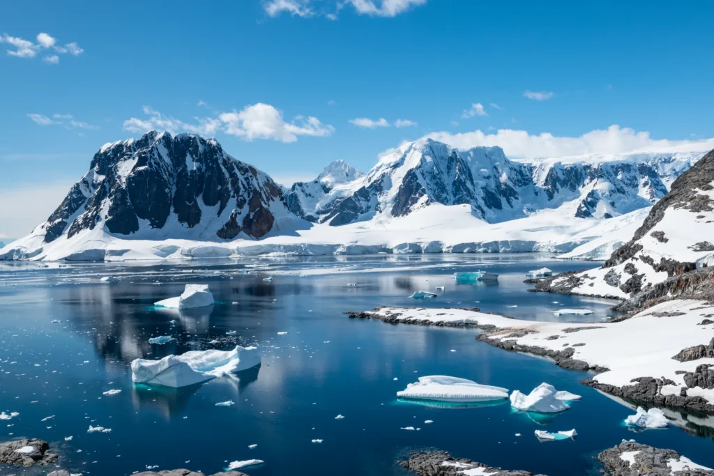 Stunning nature with snow capped mountains reflecting in the water. Port Charcot.