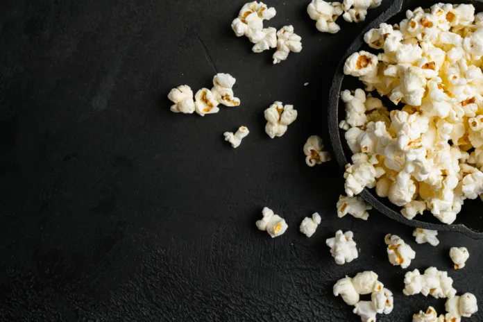 tasty-salted-popcorn-on-black-dark-stone-table-background-top-view-flat-lay-with-copy-space-for-text-stockpack-istock Tasty salted popcorn, on black dark stone table background, top view flat lay, with copy space for text