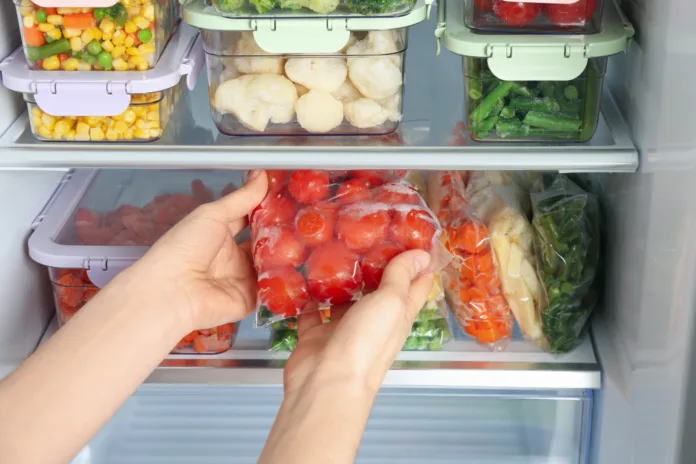 woman-taking-plastic-bag-with-frozen-tomatoes-from-refrigerator-closeup-stockpack-istock Woman taking plastic bag with frozen tomatoes from refrigerator, closeup