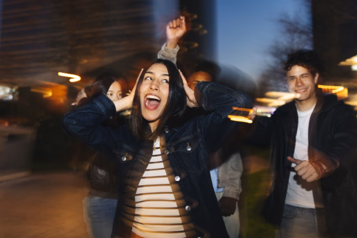 diverse-group-of-young-adult-friends-dancing-and-celebrating-outdoors-at-night-motion-blur-creating-dynamic-movement-stockpack-istock Diverse group of young adult friends dancing and celebrating outdoors at night, motion blur creating dynamic movement