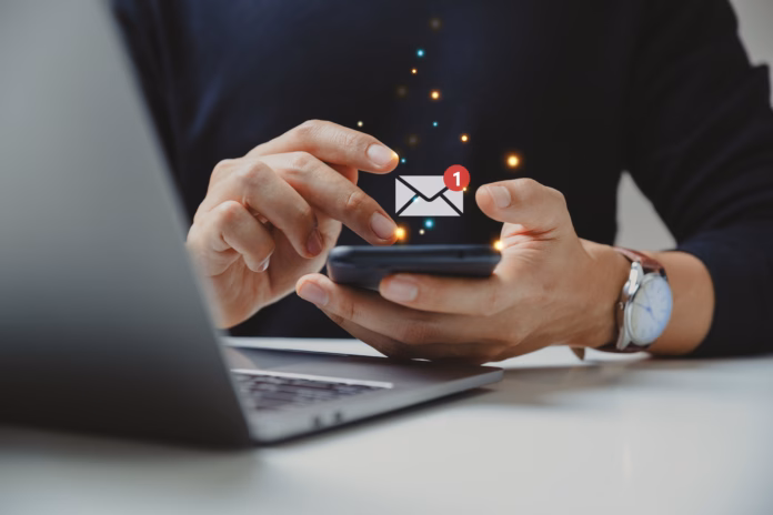 hand-of-businessman-using-smartphone-for-email-with-notification-alert-online-communication-concept-stockpack-istock Hand of businessman using smartphone for email with notification alert, Online communication concept.