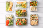 Healthy meal. Containers with different products on white wooden table, flat lay