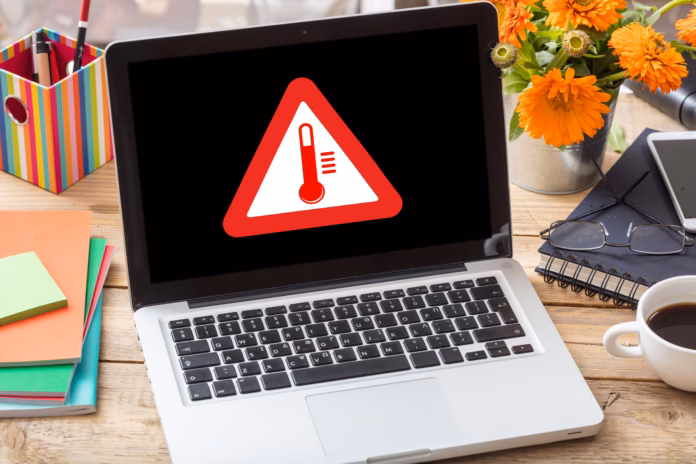 high-temperature-warning-sign-on-a-laptop-screen-computer-overheating-concept-heavy-load-and-hot-weather-danger-business-office-desk-background-stockpack-istock High temperature warning sign on a laptop screen. Computer overheating concept. Heavy load and hot weather danger. Business office desk background.