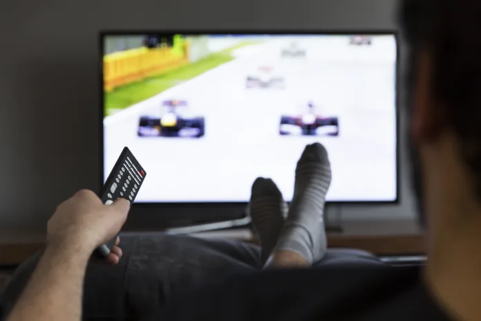 man-watching-car-race-on-tv-stockpack-istock man watching car race on tv