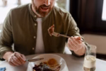 Mid adult man enjoying a gourmet meal in a restaurant setting, having dinner