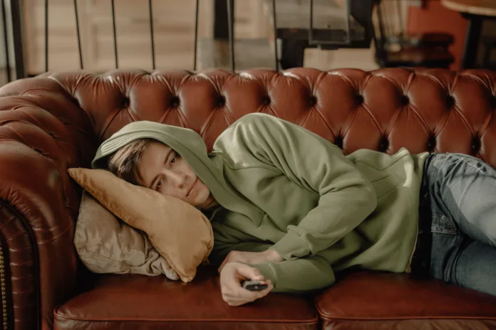 person-in-brown-robe-lying-on-brown-leather-couch-stockpack-pexels Person in brown robe lying on brown leather couch