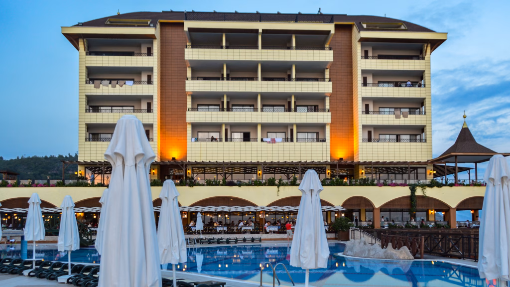 Alanya. Turkey. June 06, 2015: Large seaside resort hotel with swimming pool and terraces in Alanya, Turkey during summer evening. Popular Mediterranean travel destination