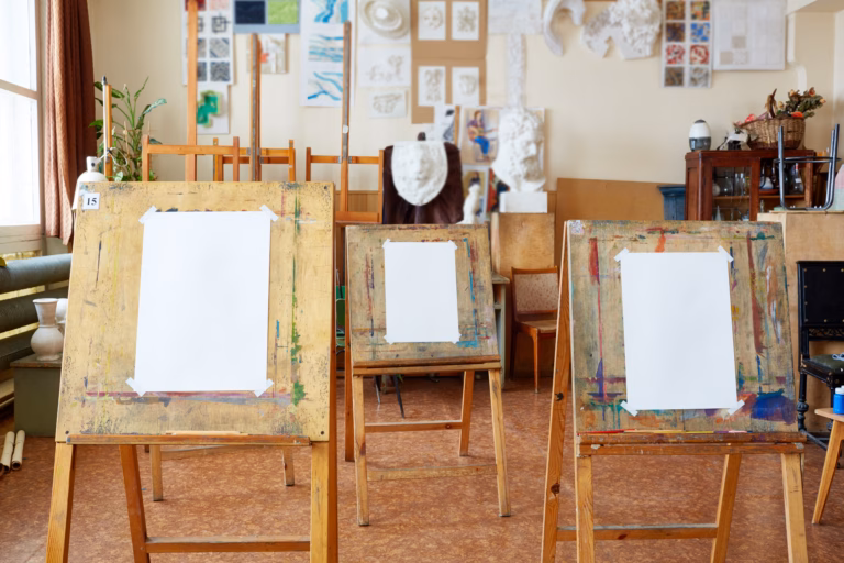 Easels with empty canvases in art studio