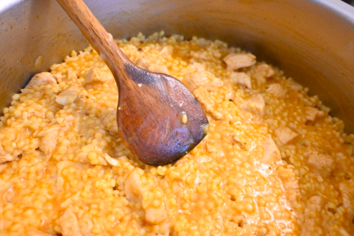 egg-barley-stew-with-meat-cooks-in-a-pot-with-a-wooden-spoon-the-close-up-shows-a-homemade-comfort-food-dish-with-a-warm-orange-color-and-rustic-kitchen-setting-stockpack-istock Egg barley stew with meat cooks in a pot with a wooden spoon. The close-up shows a homemade comfort food dish with a warm orange color and rustic kitchen setting.