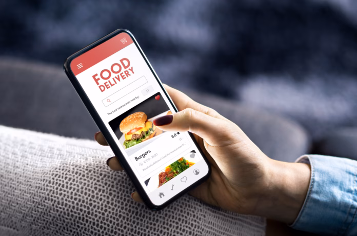 food-delivery-app-order-in-phone-online-restaurant-menu-fast-take-away-service-in-mobile-takeout-burger-or-pizza-websitewoman-with-smartphone-in-hand-deliver-lunch-home-stockpack-istock Food delivery app order in phone. Online restaurant menu. Fast take away service in mobile. Takeout burger or pizza website.Woman with smartphone in hand. Deliver lunch home.