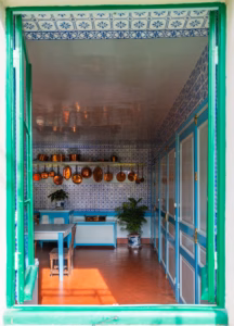 Giverny, France - October 12, 2018: The kitchen and copper pans of Claude Monet's house in Giverny seen through an open window.