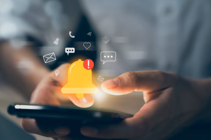 hand-using-smartphone-with-showing-the-bell-icon-and-notifications-of-new-messages-on-application-stockpack-istock Hand using smartphone with showing the bell icon and notifications of new messages on application.