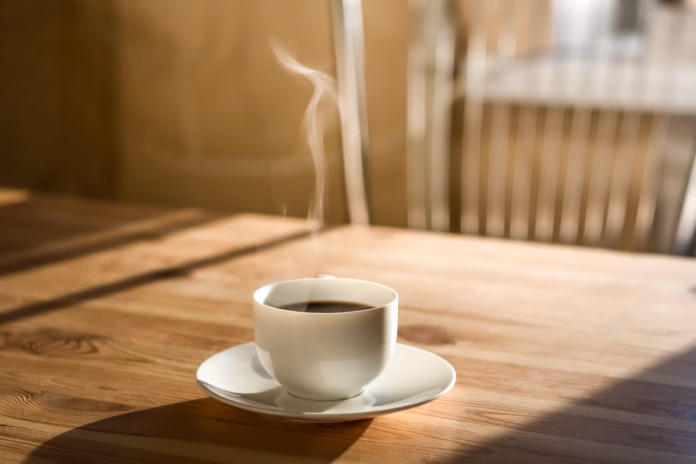 kitchen-interior-in-natural-light-wood-table-with-hot-steaming-drink-on-it-stockpack-istock Kitchen interior in natural light, wood table with hot steaming drink on it
