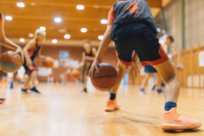 young-basketball-player-on-practice-session-youth-basketball-team-bouncing-balls-on-sports-court-group-of-kids-training-basketball-together-stockpack-istock Young Basketball Player on Practice Session. Youth Basketball Team Bouncing Balls on Sports Court. Group of Kids Training Basketball Together