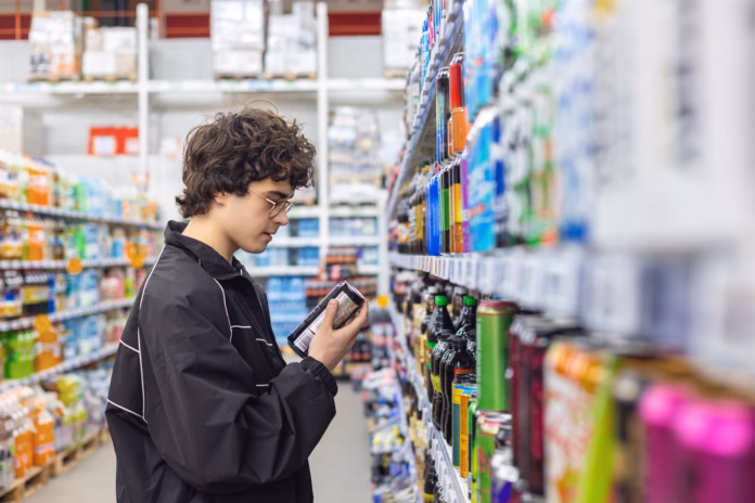 adolsent-boy-reading-beverage-label-while-shopping-in-supermarket-unhealthy-beverage-habits-and-health-risk-stockpack-istock Adolsent boy reading beverage label while shopping in supermarket. unhealthy beverage habits and health risk