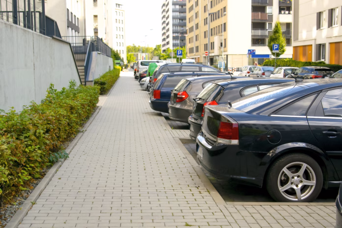 long-row-of-modern-cars-parking-tightly-along-city-road-street-urban-transportation-infrastructureparking-problems-in-residential-districttechnologyvehicles-parked-by-curb-stockpack-istock Long row of modern cars parking tightly along city road street. Urban transportation infrastructure,parking problems in residential district,technology.vehicles parked by curb.