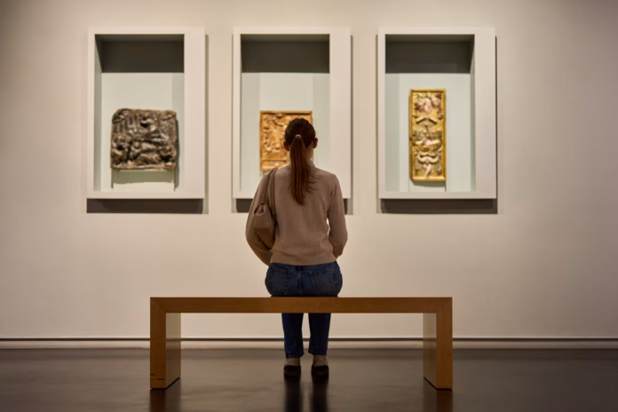 visitor-in-historical-museum-looking-at-art-object-stockpack-istock Visitor in historical museum looking at art object